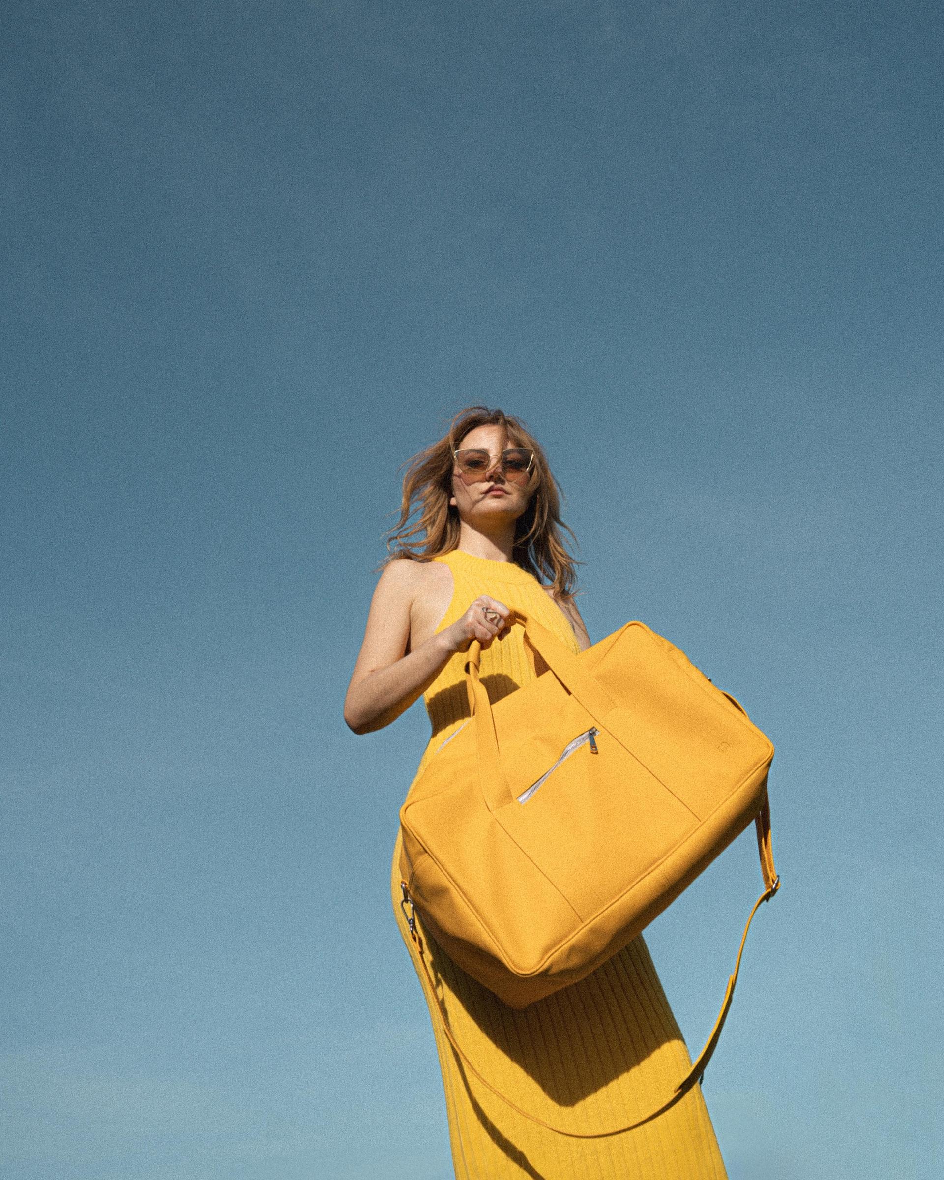 model with a big yellow vegan leather bag