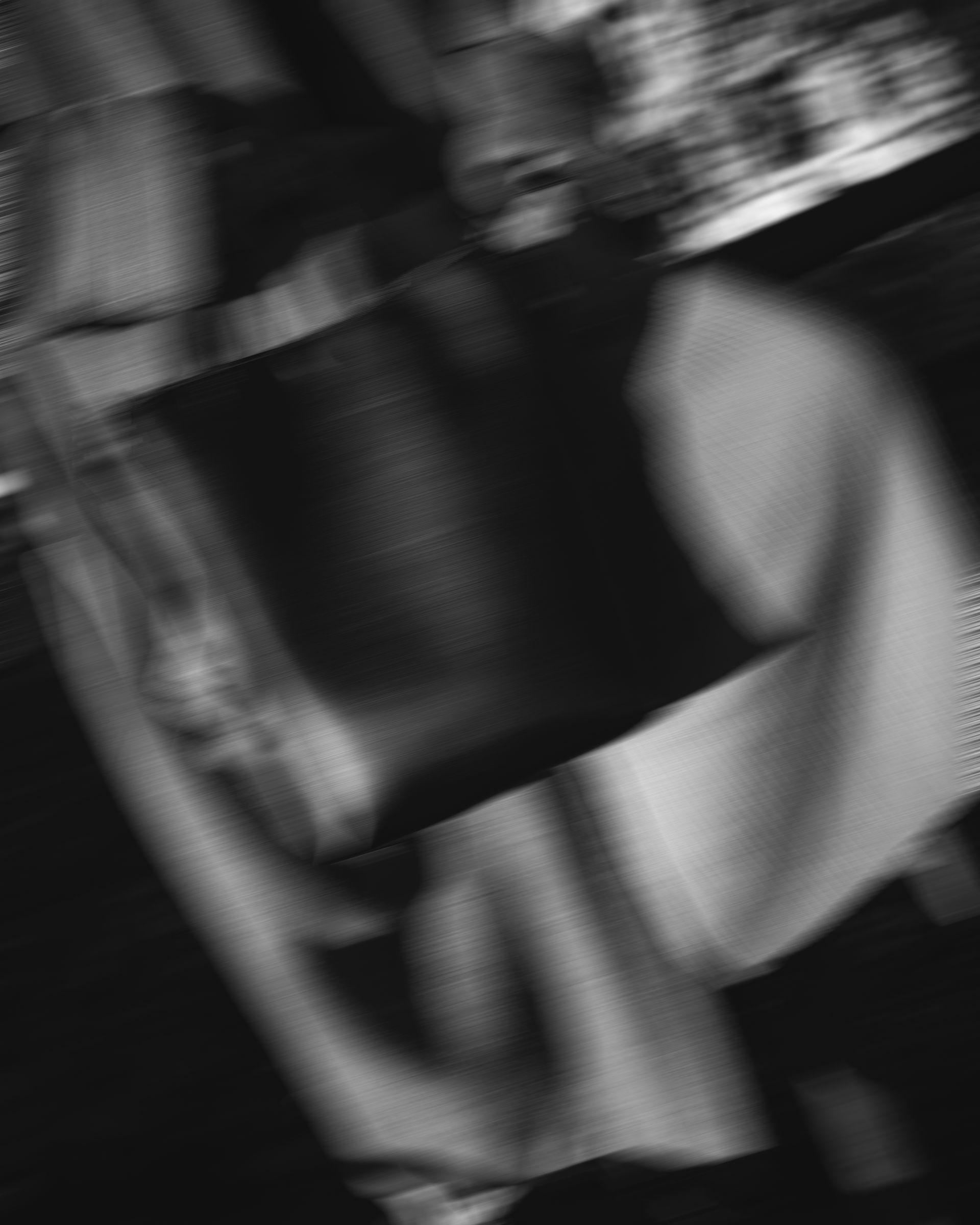 Blurry black and white photo of a black handbag