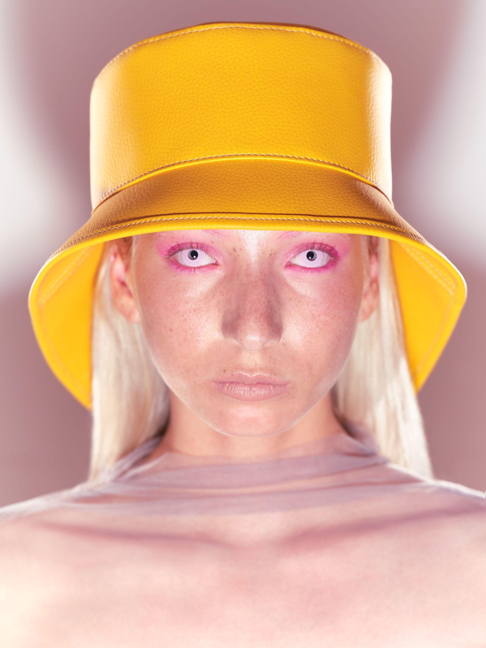 Alien looking model wearing plant based leather yellow hat