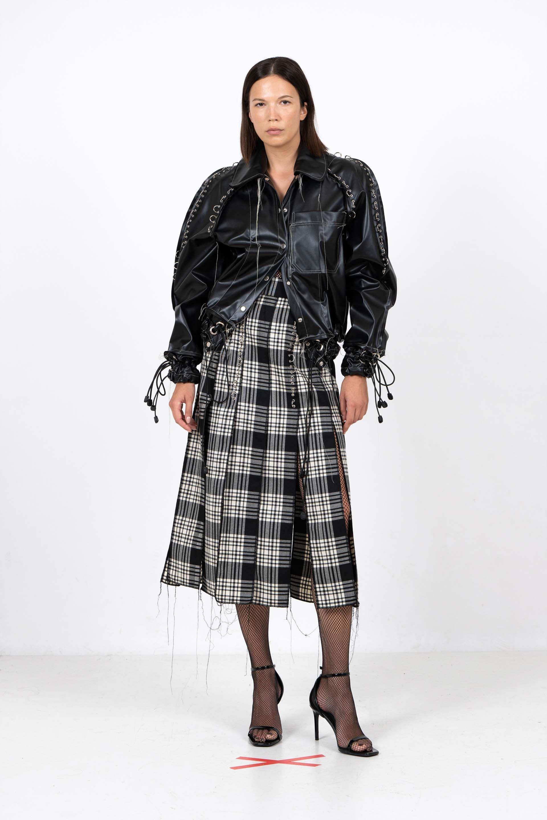 Black plant-based leather bomber jacket with metallic perforations and drawstring details, crafted from gin production waste.