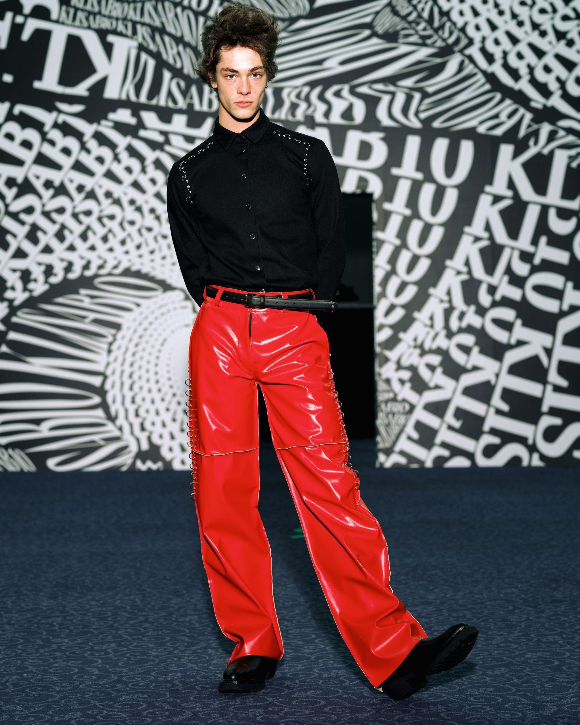 Red leather pants with metallic perforations along the sides of the legs