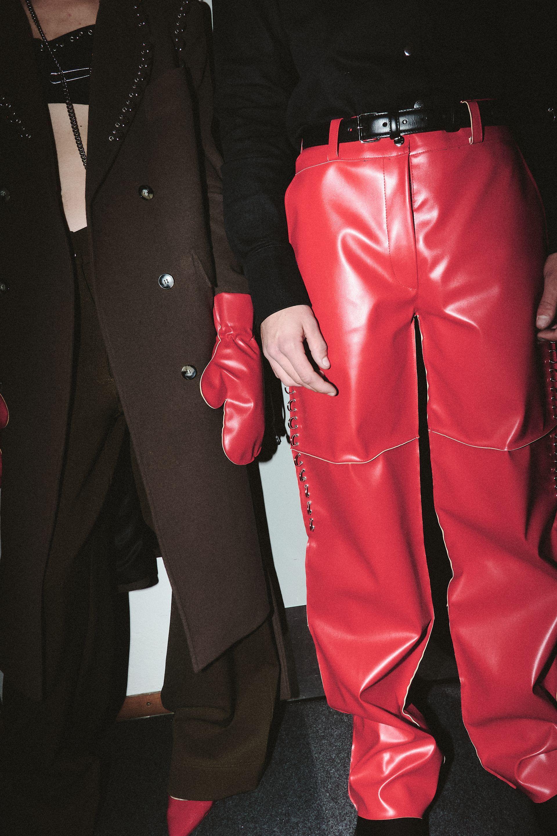 Red leather pants and glove on a fashion show by Klisab